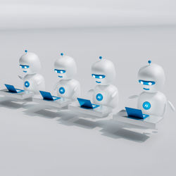 Four robots typing. Photo: Mohamed Nohassi / Unsplash