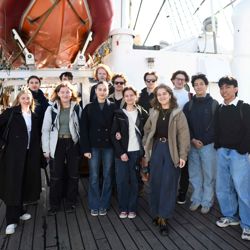 A class from Bergen Katedralskole lined up on deck aboard the Statsraad Lehmkuhl docked in Bergen.