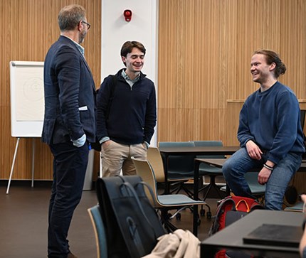 Three participants from kick-off in conversation.