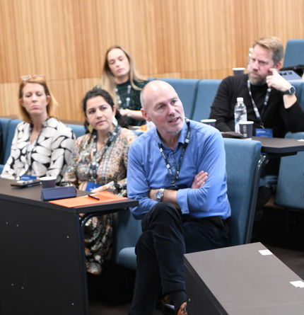 Lasse Lien seated in lecture hall